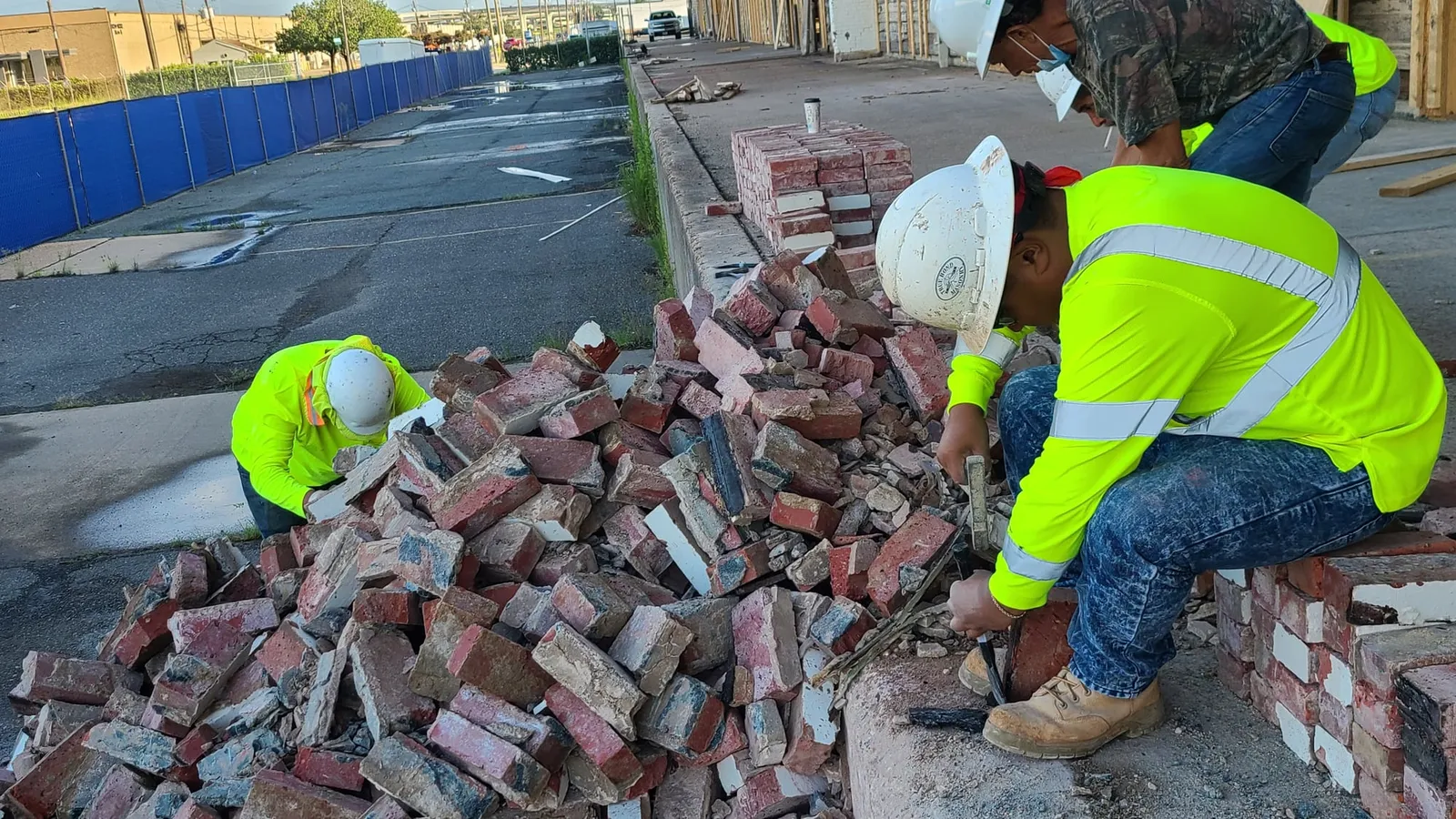 Saving the old brick: crew members sort bricks during demolition.