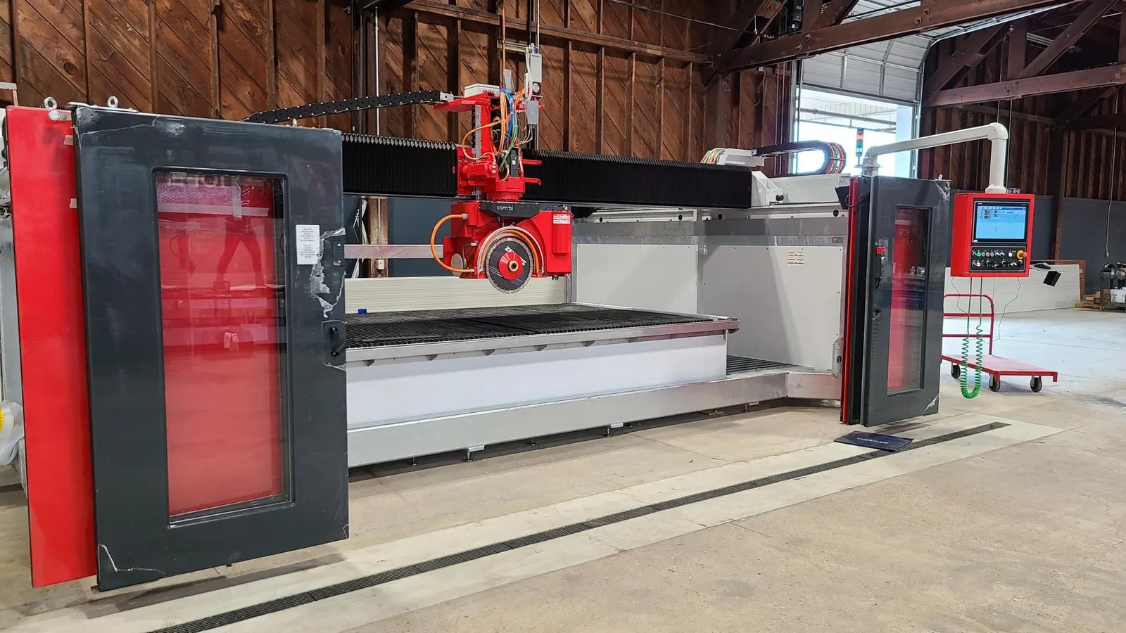 The new saw in place inside the shop, under the building’s timber trusses.