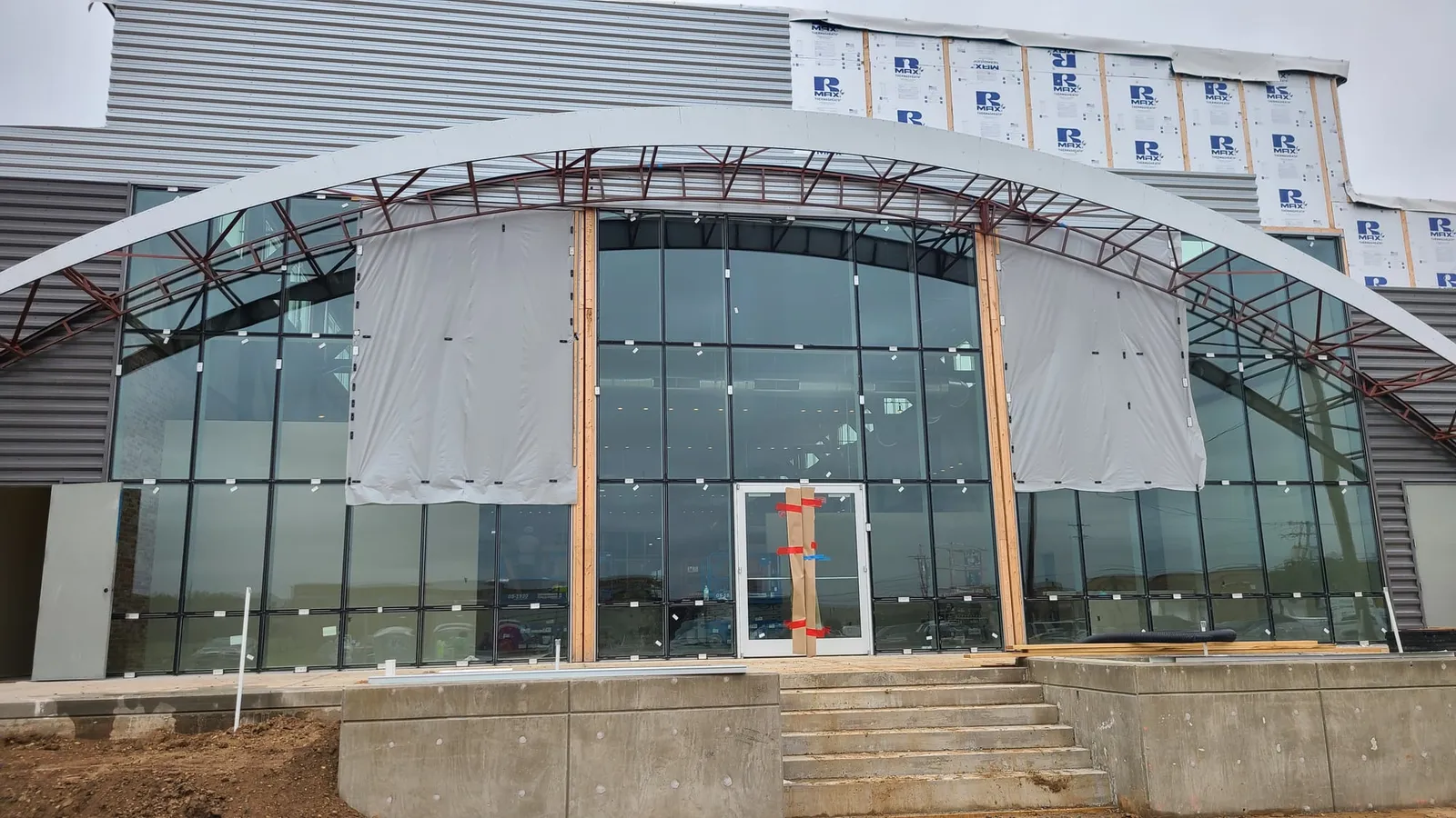 The new glass entrance goes in beneath the arch frame.