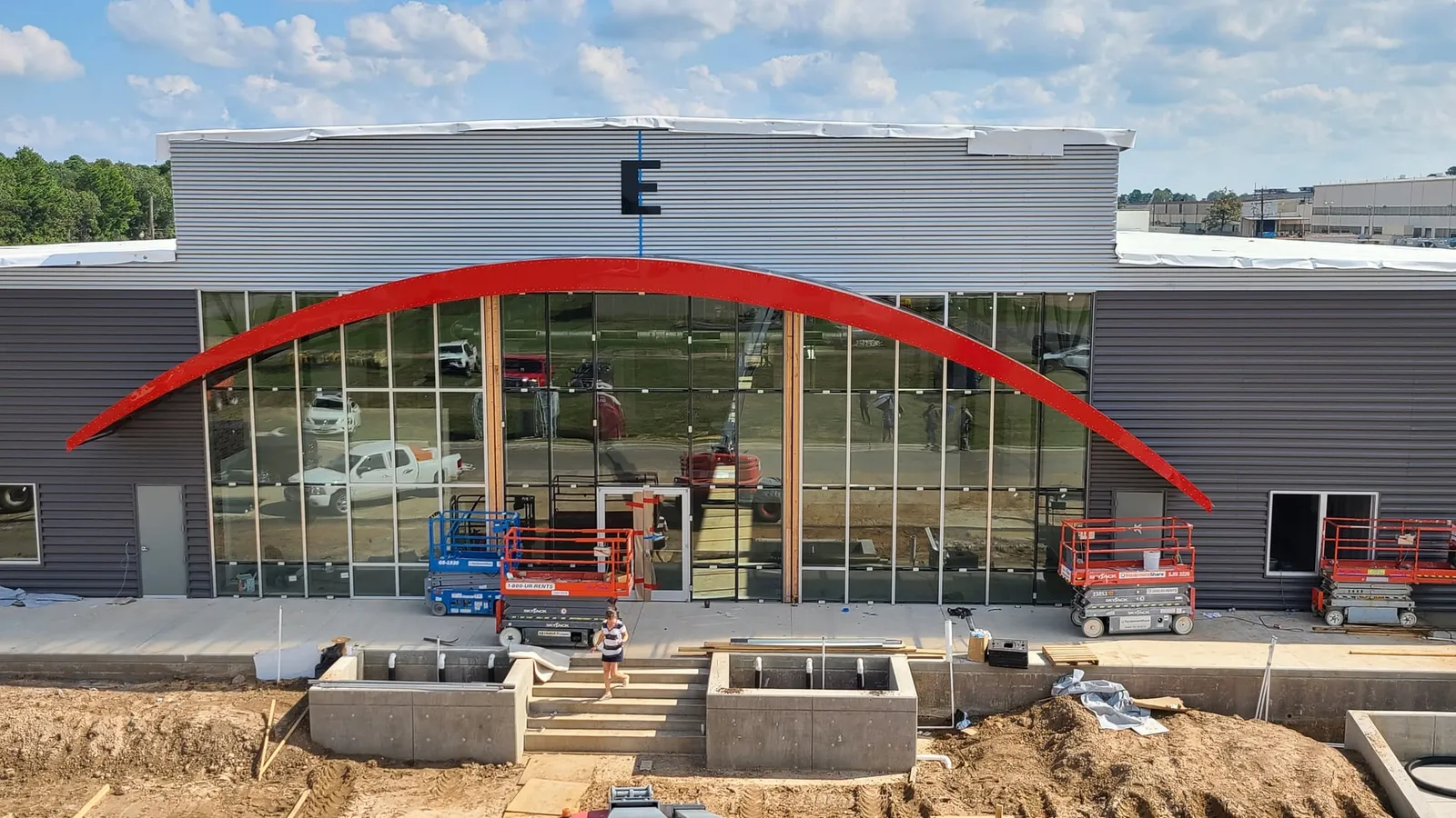 The red arch is installed over the glass entrance.