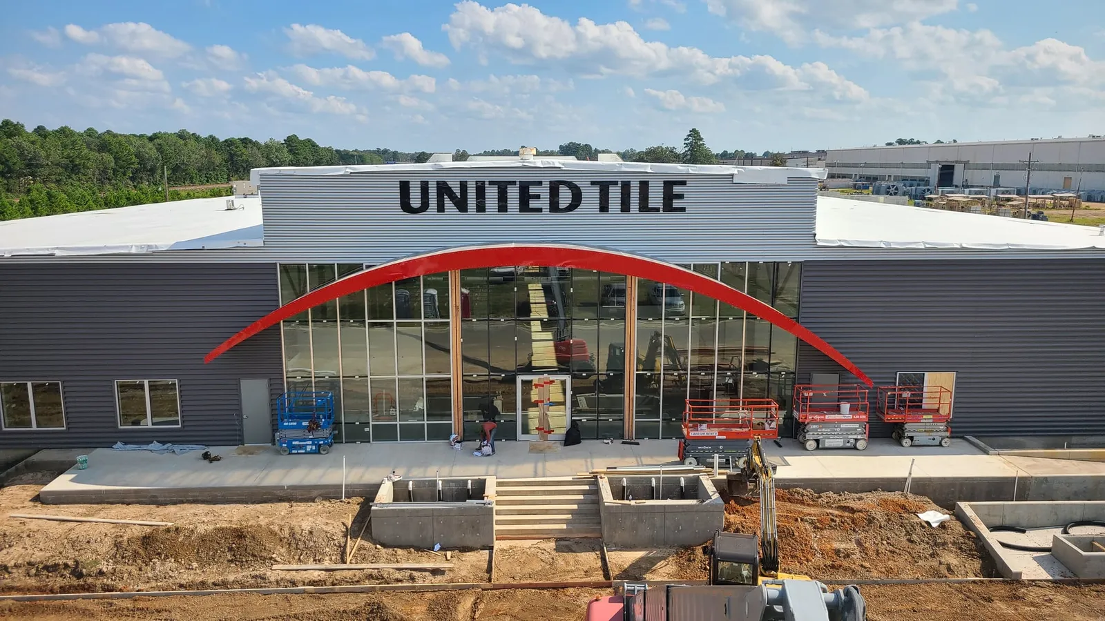 The United Tile sign goes up above the finished red arch.