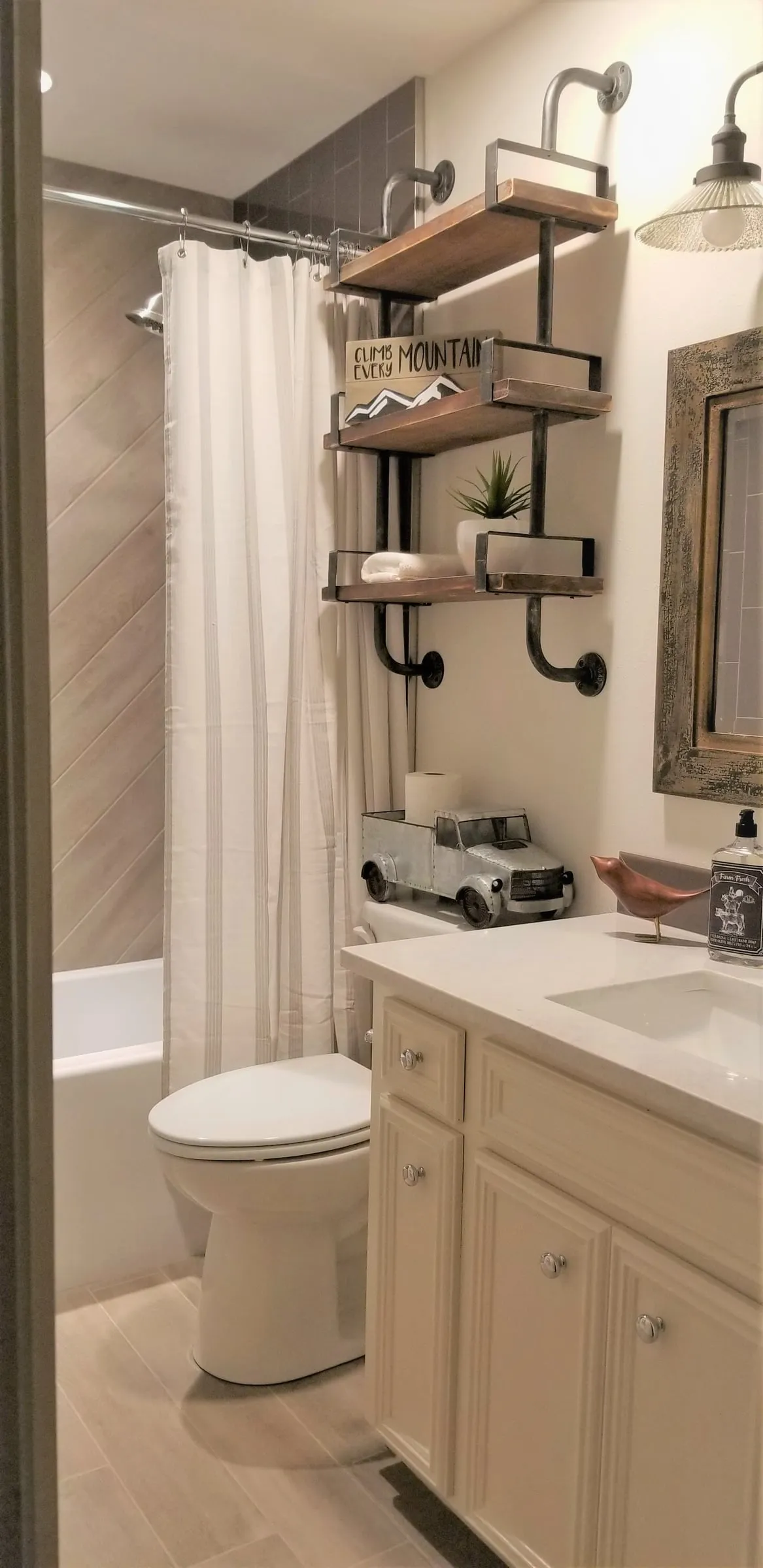 Guest bathroom with a white vanity and open shelving.