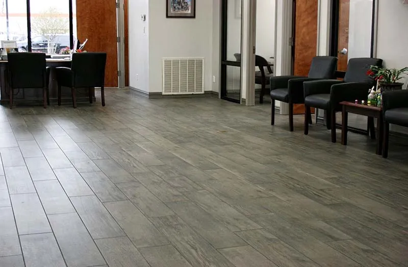 Bank lobby waiting area with gray wood-look tile floors.