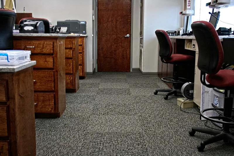 Office area where carpet meets wood-look tile.