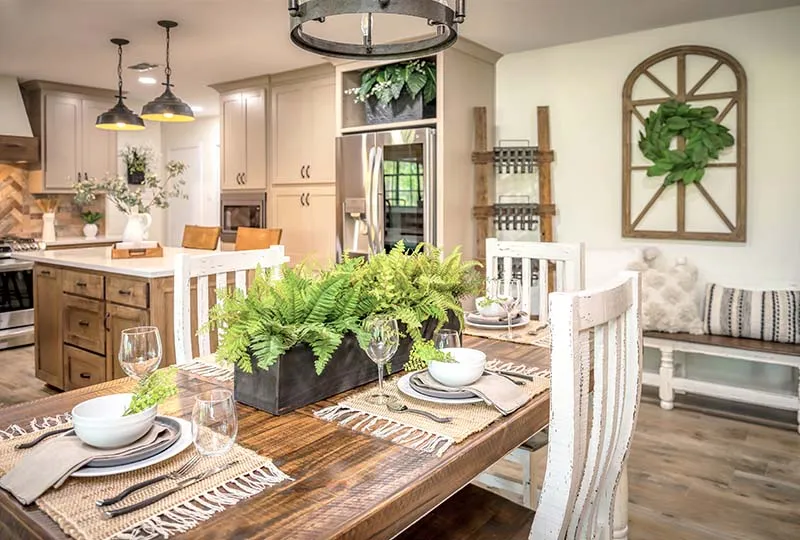 Farmhouse dining table set in front of the kitchen.