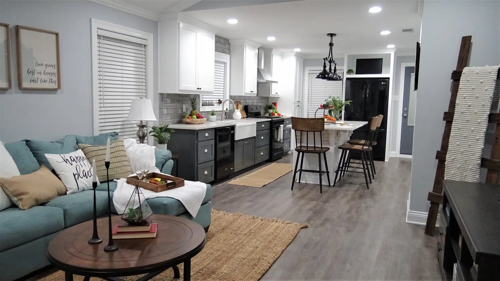 Open living room and kitchen with gray wood-look floors.