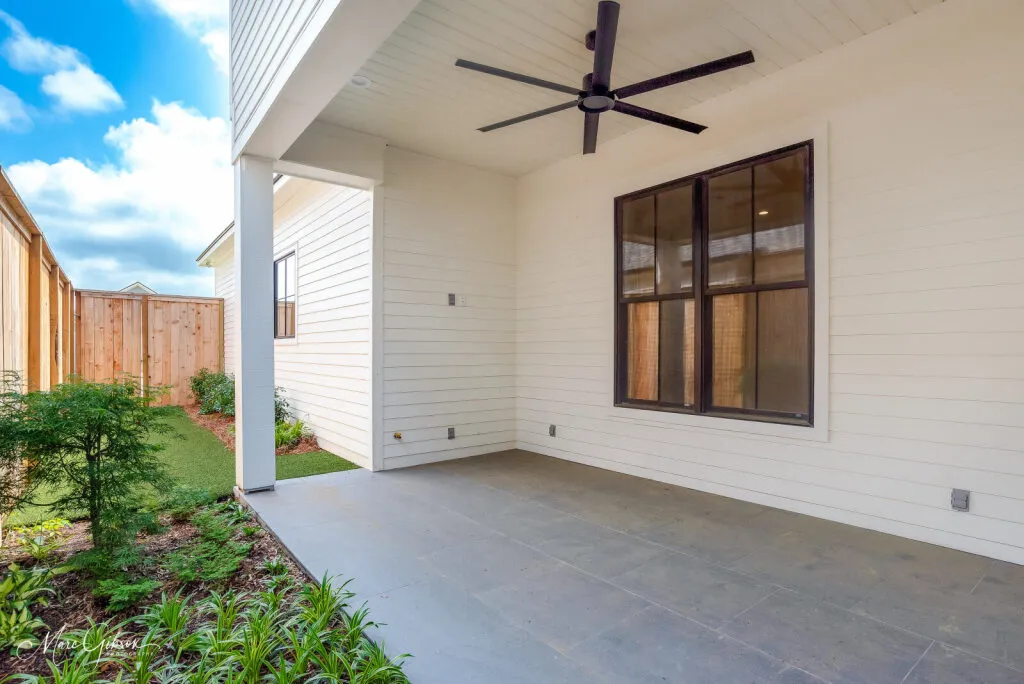 Covered back porch with a gray tile floor.