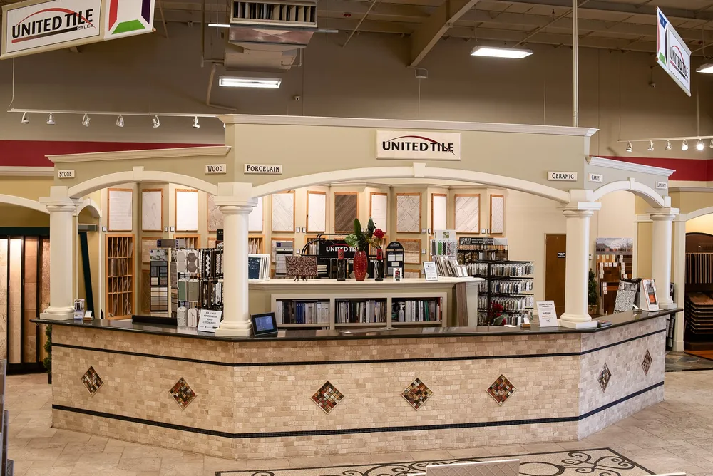 United Tile’s showroom counter at the Design Center, with arches and columns labeled stone, wood, porcelain and ceramic.
