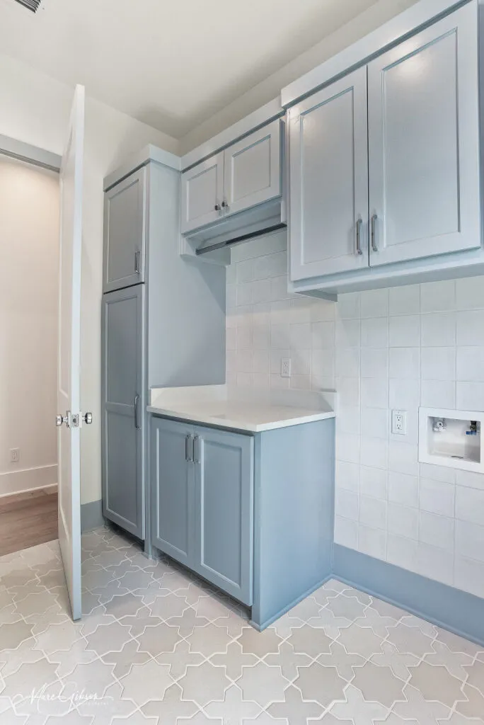Laundry room with a quartzite countertop and a star-and-cross pattern tile floor.