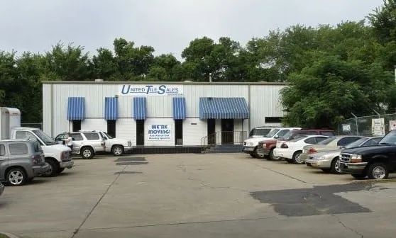 United Tile Sales building on Levy Street with blue awnings and a “We’re moving!” banner.